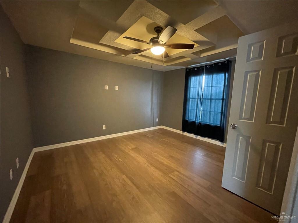 8006 Senecio Street Mission, TX 78574 - Photo 25 of 31 an empty room with wooden floor closet and windows