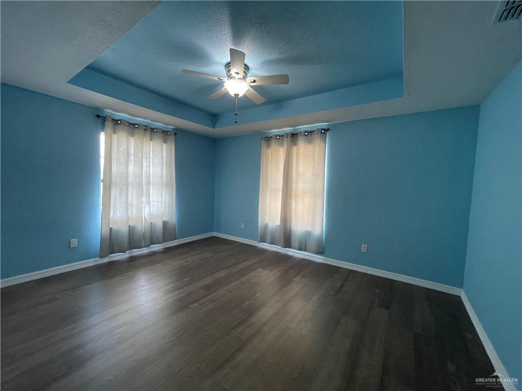 8006 Senecio Street Mission, TX 78574 - Photo 27 of 31 an empty room with wooden floor and windows