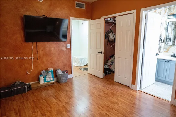 a view of a room with wooden floor and windows