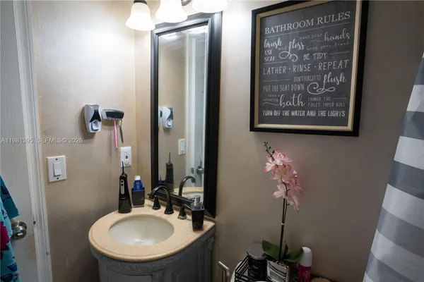 a bathroom with a sink a mirror and a toilet