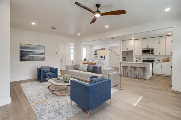 a living room with furniture and kitchen view