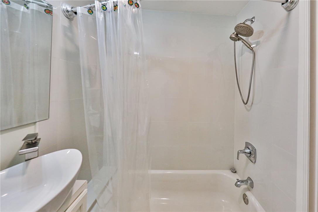 5599 Minks Pond Road Bushkill, PA 18324 - Photo 23 of 64 A well-appointed bath features a shower/tub combination with a sleek, modern faucet.