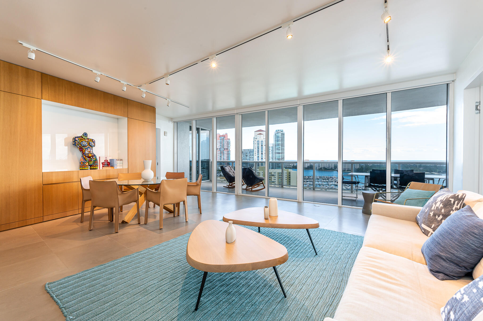 400 Alton Road, Unit 1808 Miami Beach, FL 33139 - Photo 2 of 17 a living room with furniture a rug and a large window