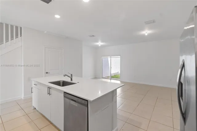 a kitchen with a sink and a refrigerator