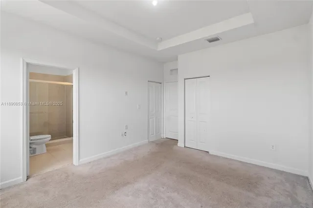 a view of an empty room and a bathroom