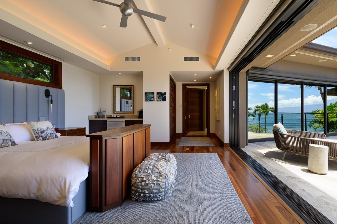 4809 Lower Honoapiilani Road Lahaina, HI 96761 - Photo 22 of 49 a bedroom with furniture and large windows