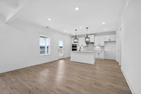 a view of kitchen with wooden floor and windows