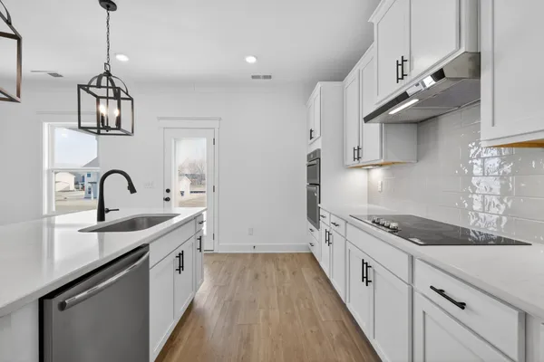 a kitchen with stainless steel appliances granite countertop a sink and cabinets