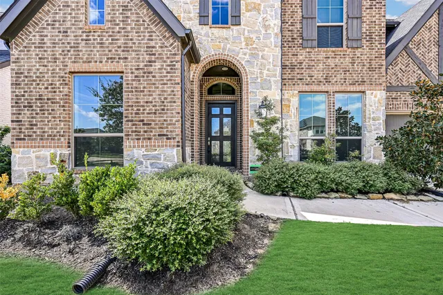 a front view of a house with garden