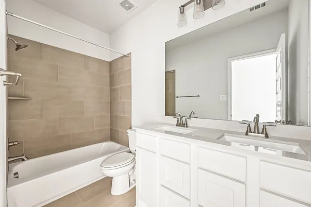 a bathroom with a granite countertop sink a toilet a mirror and shower
