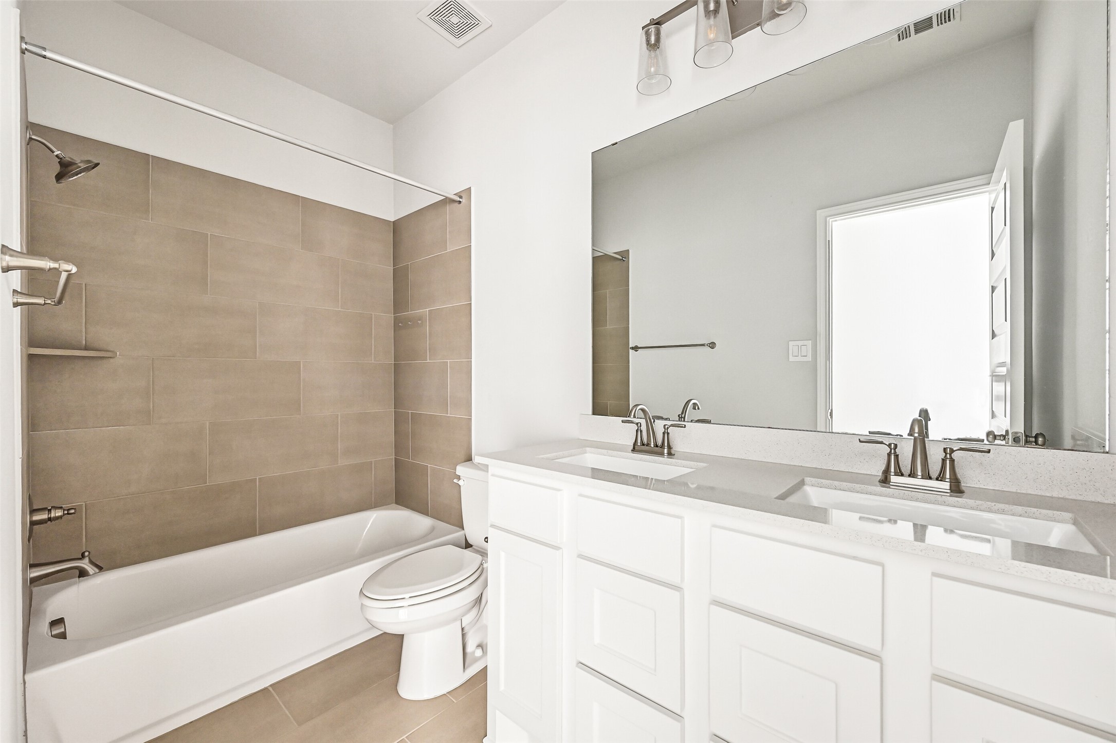 28907 Ridge Valley Court Fulshear, TX 77441 - Photo 29 of 36 a bathroom with a granite countertop sink a toilet a mirror and shower