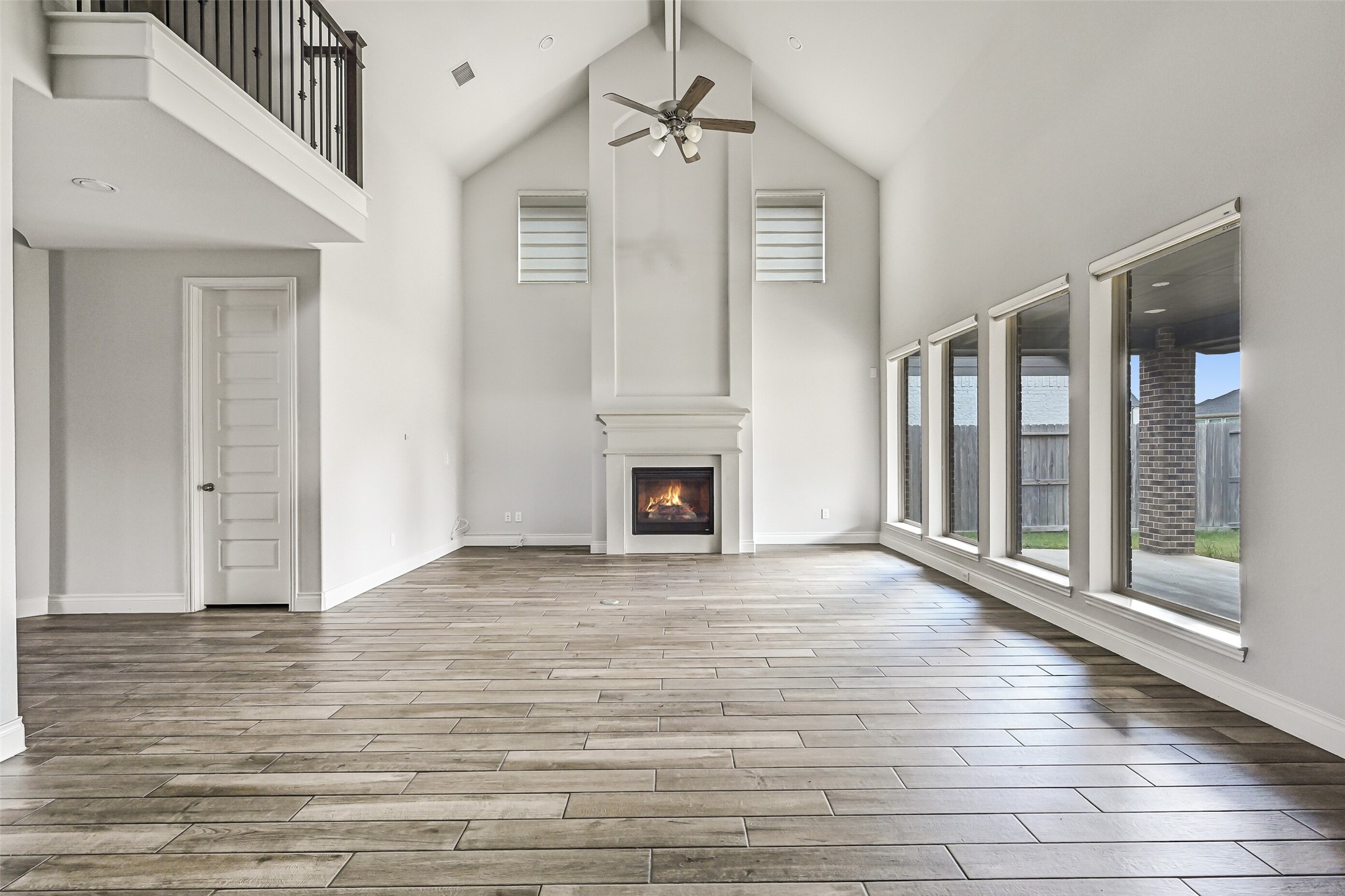 28907 Ridge Valley Court Fulshear, TX 77441 - Photo 4 of 36 a view of empty room with wooden floor and fireplace