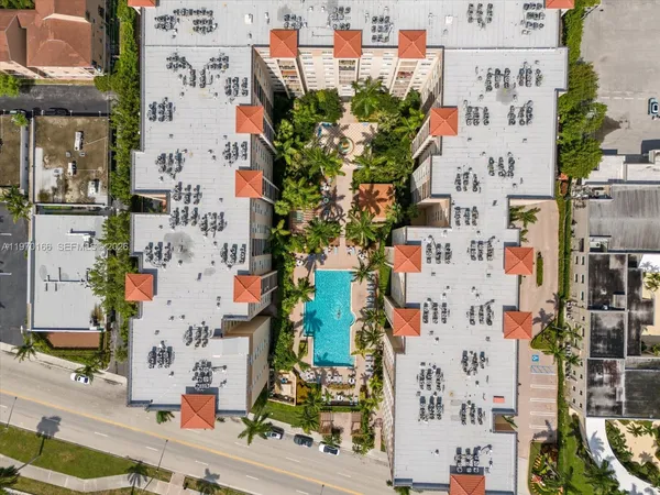a room with pool table and windows