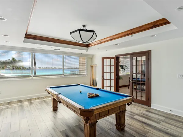 a view of swimming pool with outdoor seating and lake view
