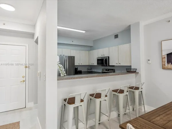 a kitchen with stainless steel appliances a refrigerator and microwave