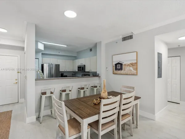 a view of a dining room with furniture and wooden floor