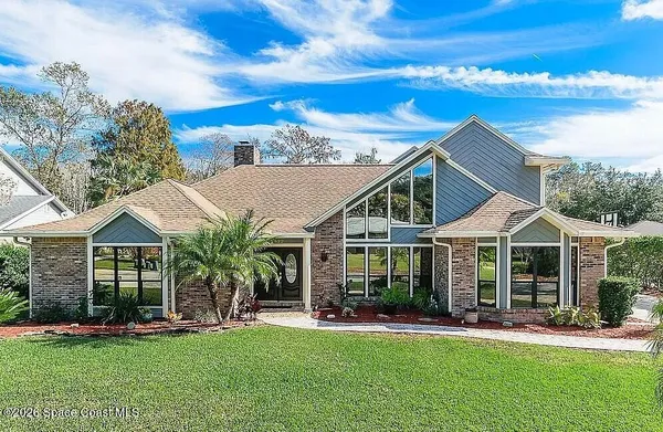 a front view of a house with a yard table and chairs