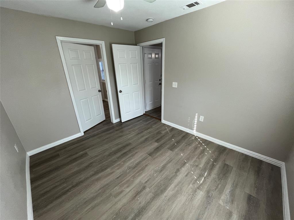 8335 Tenino Street Dallas, TX 75217 - Photo 12 of 22 Unfurnished bedroom with a ceiling fan and wood finished floors