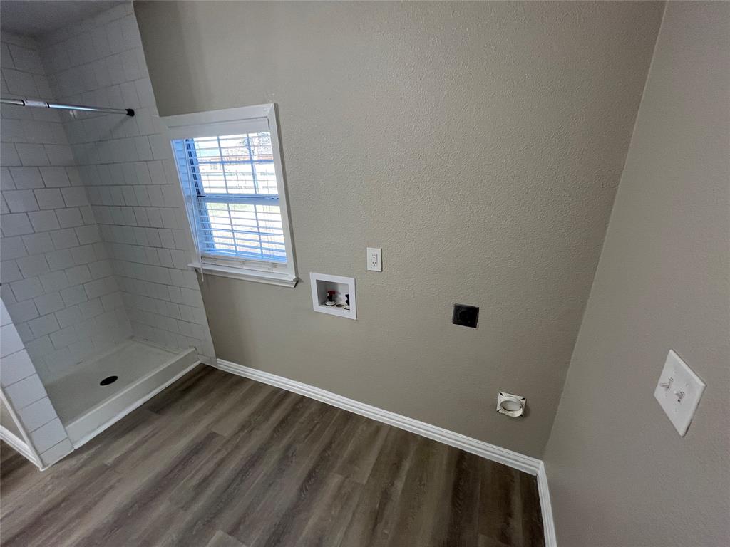 8335 Tenino Street Dallas, TX 75217 - Photo 13 of 22 Laundry room with washer hookup, wood finished floors, hookup for an electric dryer, and a textured wall