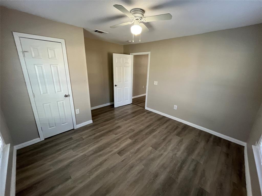 8335 Tenino Street Dallas, TX 75217 - Photo 16 of 22 Unfurnished bedroom featuring dark wood-type flooring and ceiling fan