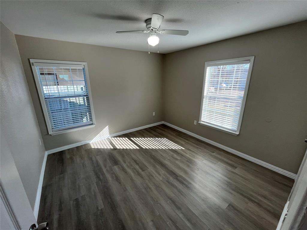 8335 Tenino Street Dallas, TX 75217 - Photo 17 of 22 Spare room with dark wood-style floors and ceiling fan