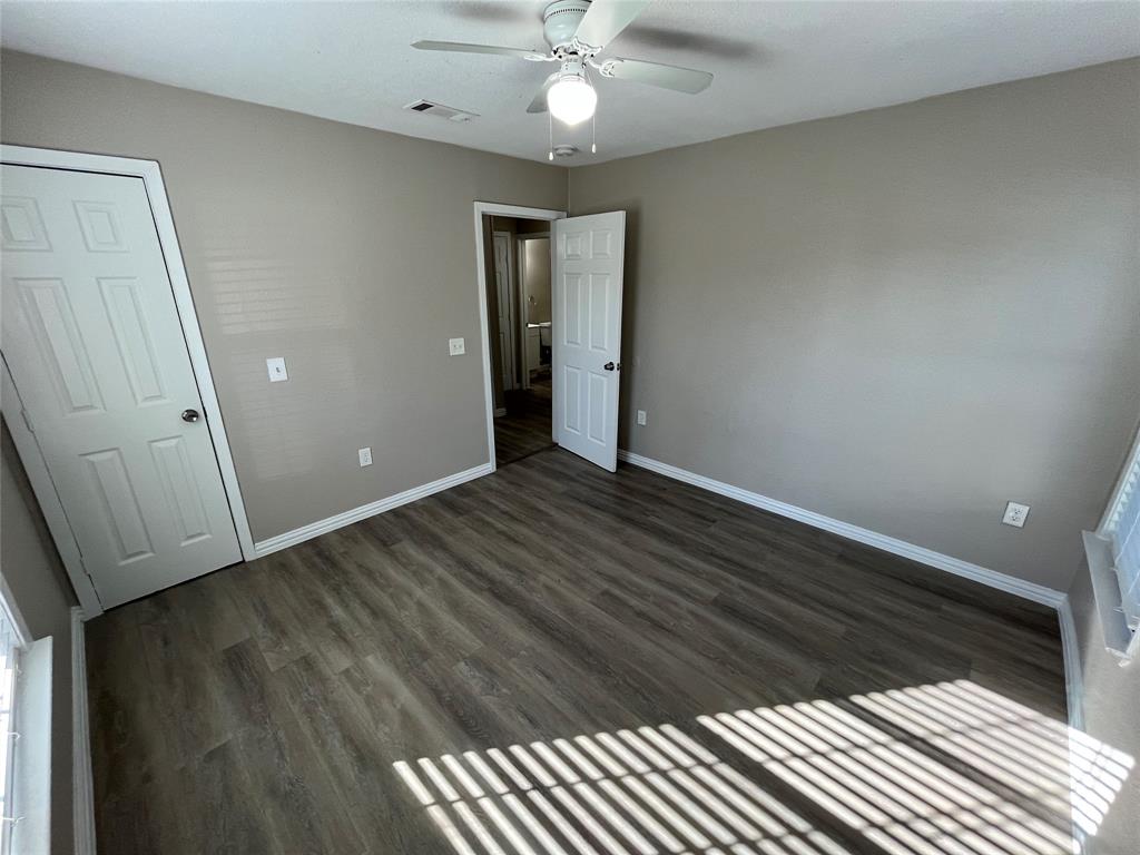 8335 Tenino Street Dallas, TX 75217 - Photo 18 of 22 Unfurnished bedroom featuring dark wood-type flooring and ceiling fan