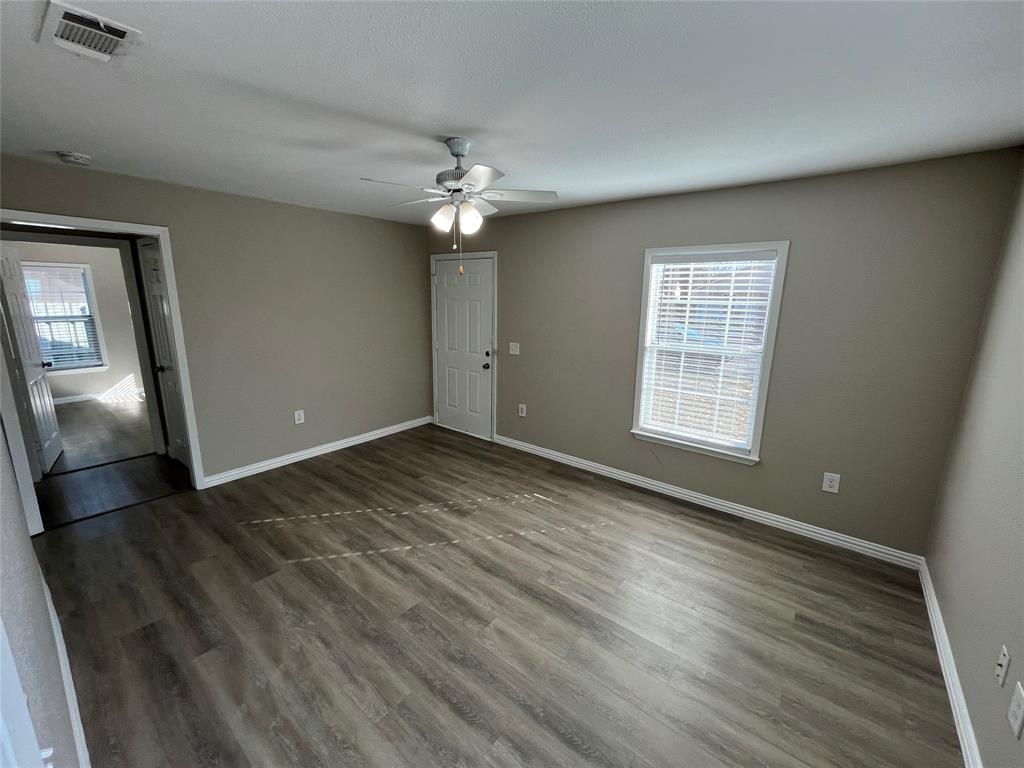 8335 Tenino Street Dallas, TX 75217 - Photo 5 of 22 Empty room featuring wood finished floors and ceiling fan