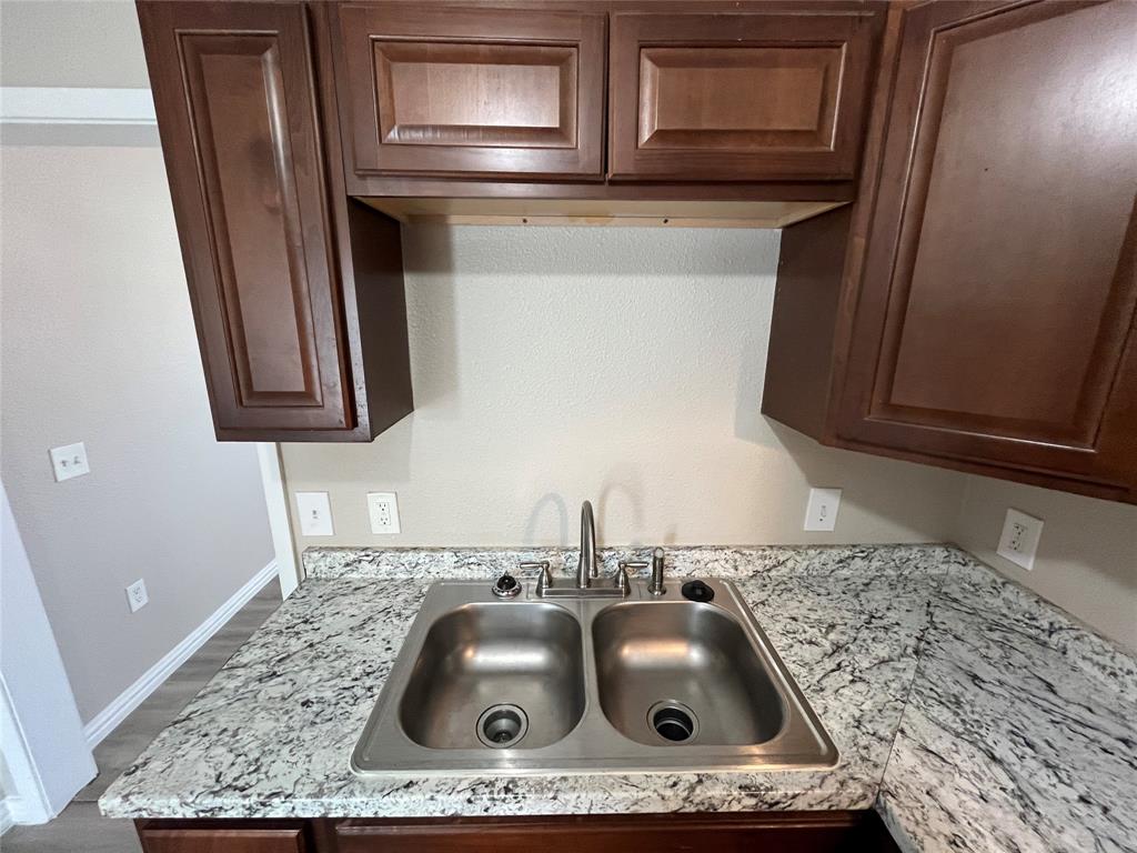 8335 Tenino Street Dallas, TX 75217 - Photo 8 of 22 Kitchen view of light countertops and dark brown cabinets