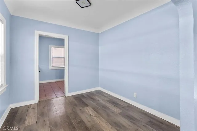 a kitchen with granite countertop a sink a stove and cabinets