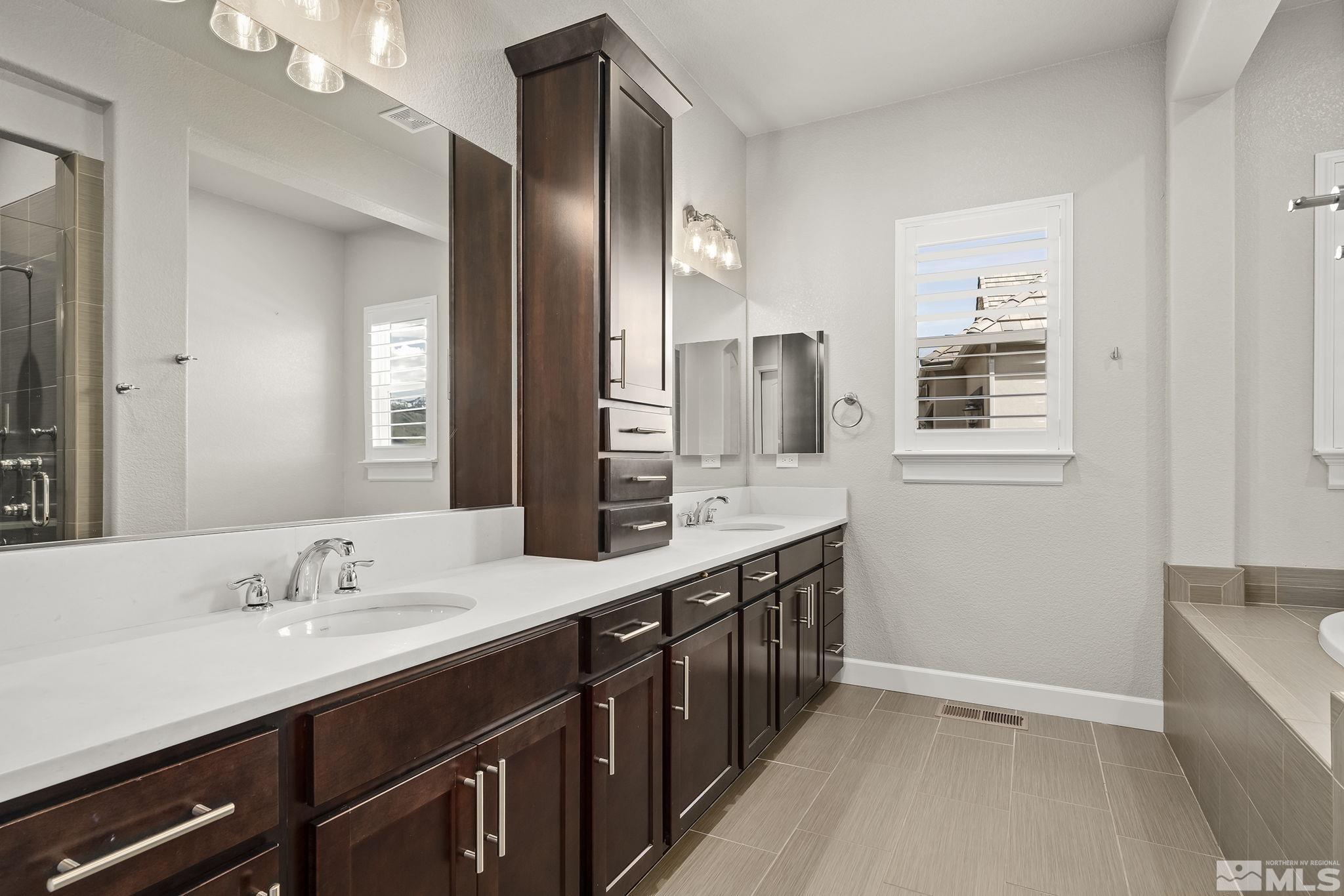 1755 Laurel Ridge Court Reno, NV 89523 - Photo 20 of 38 a spacious bathroom with a double vanity sink and mirror