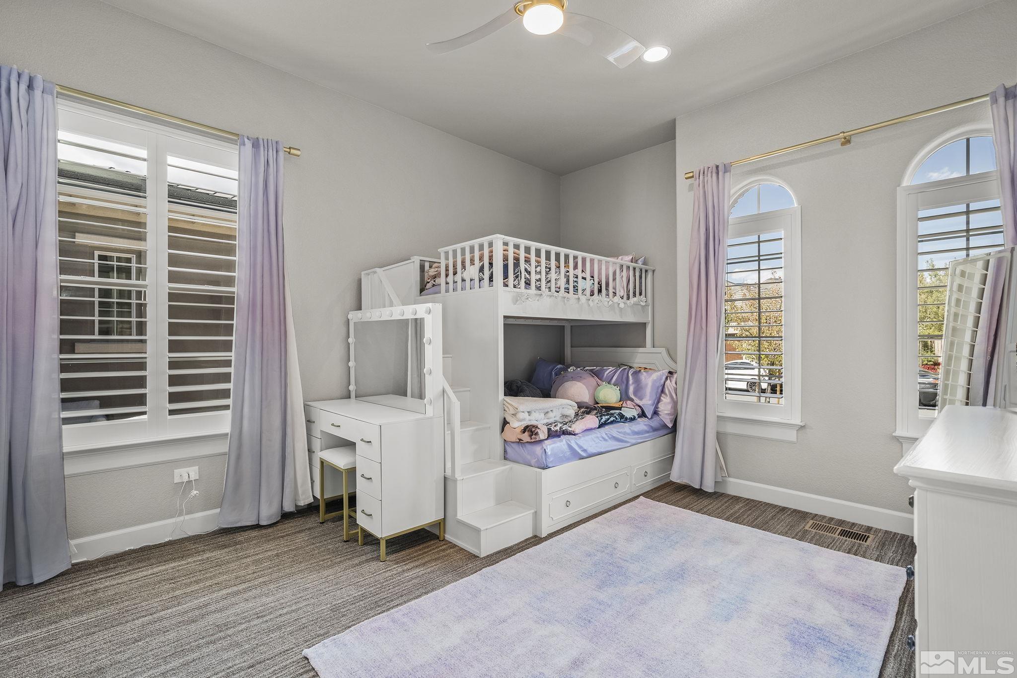 1755 Laurel Ridge Court Reno, NV 89523 - Photo 24 of 38 a bedroom with a baby bed a couch and a window