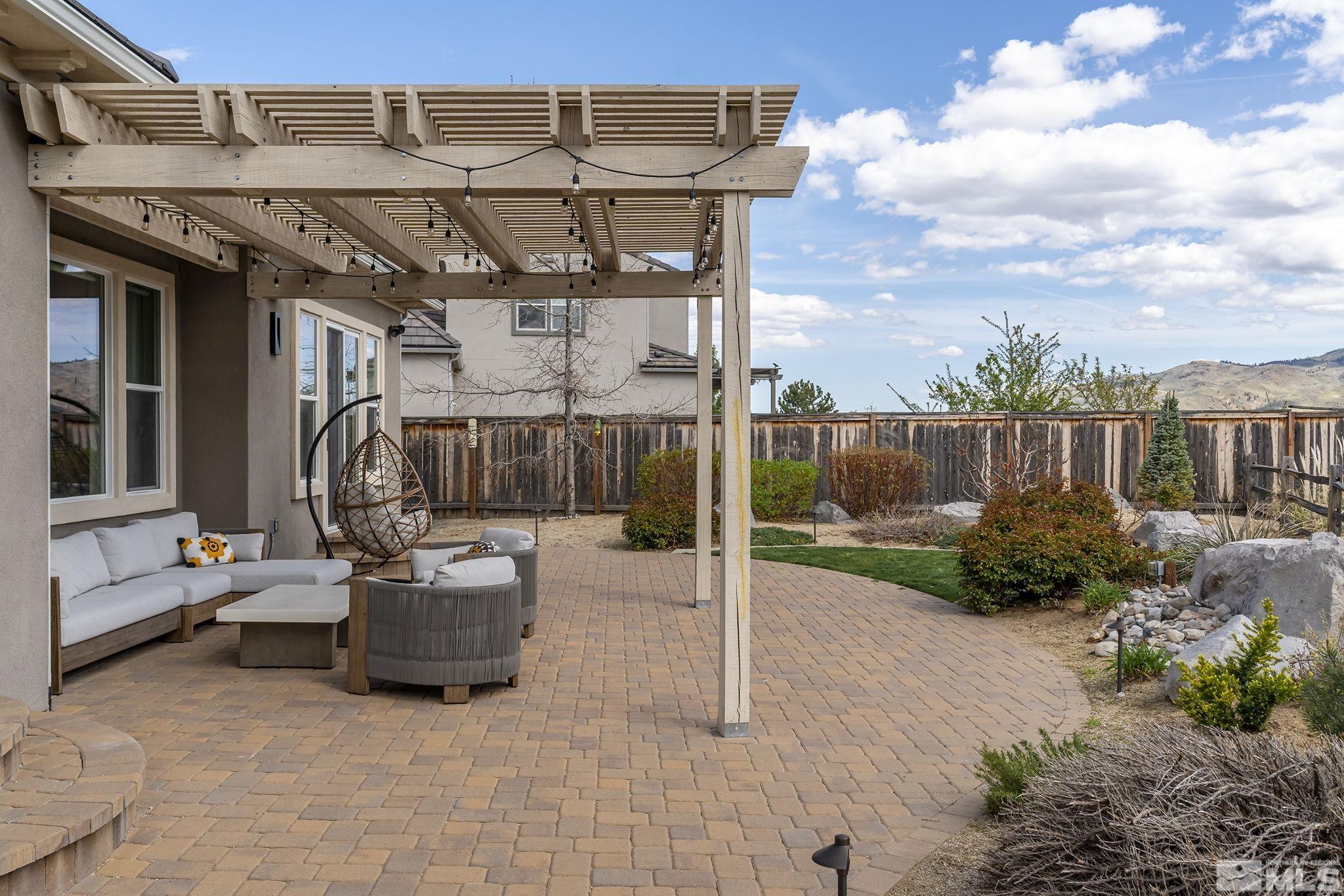 1755 Laurel Ridge Court Reno, NV 89523 - Photo 36 of 38 a view of a patio with table and chairs potted plants with wooden fence
