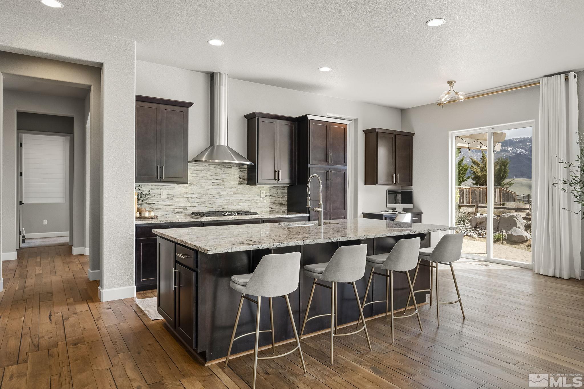 1755 Laurel Ridge Court Reno, NV 89523 - Photo 8 of 38 a kitchen with stainless steel appliances granite countertop wooden floor window and chairs