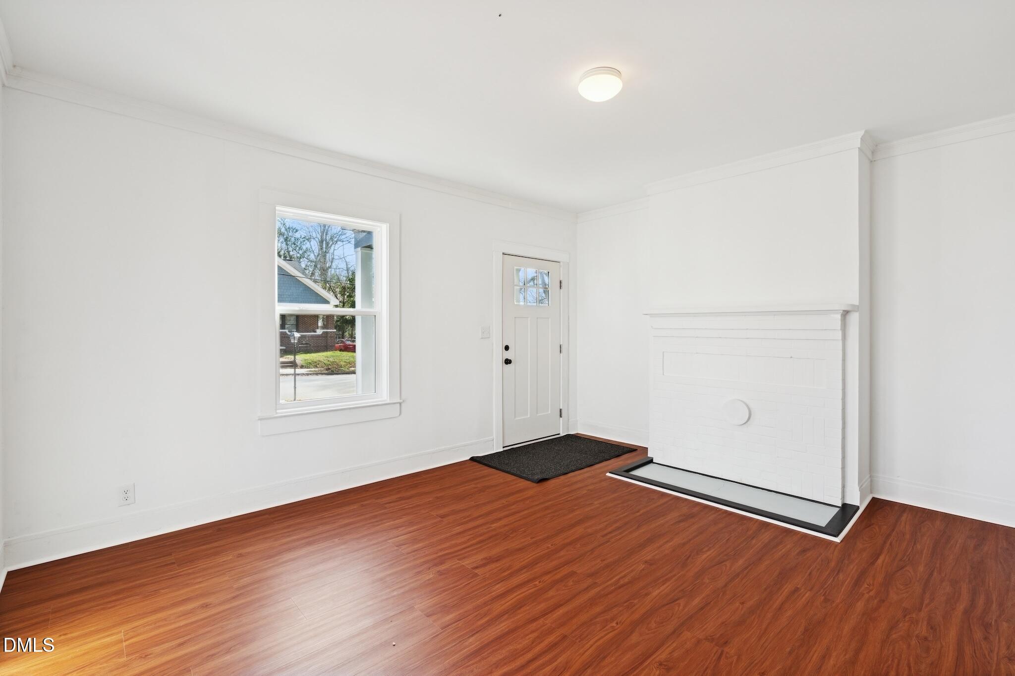 705 North Driver Street Durham, NC 27703 - Photo 10 of 46 an empty room with wooden floor and windows