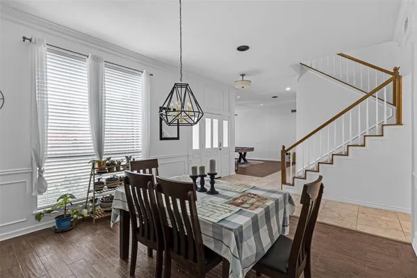 a view of a a dining room with furniture window and wooden floor