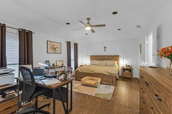 a bedroom with a bed and wooden furniture