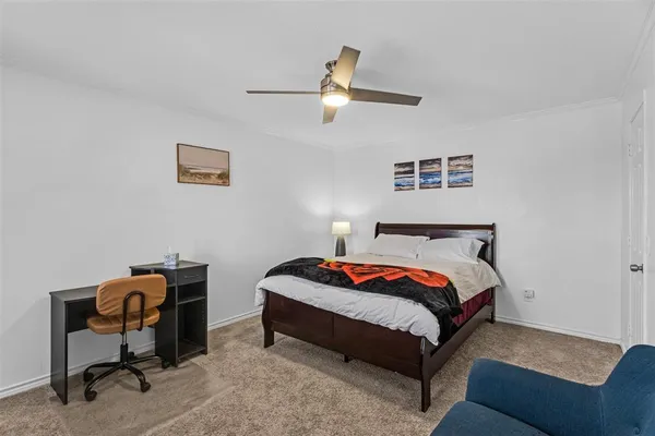 a bedroom with a bed and a desk