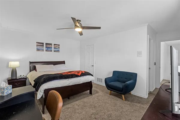 a bedroom with bed and a chair