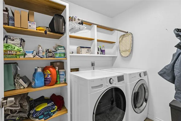 a view of storage and utility room with washer and dryer