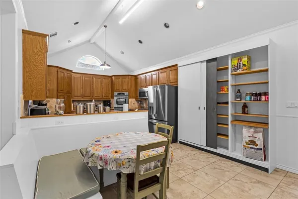 a kitchen with stainless steel appliances granite countertop a refrigerator and a stove top oven