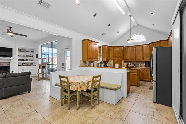 a large kitchen with a table and chairs