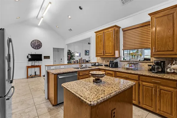 a kitchen with a sink a counter top space and appliances