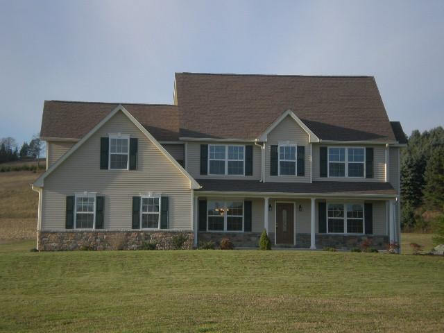 6002 Gilbert Road Gilbert, PA 18331 - Photo 1 of 22 a front view of a house with a garden