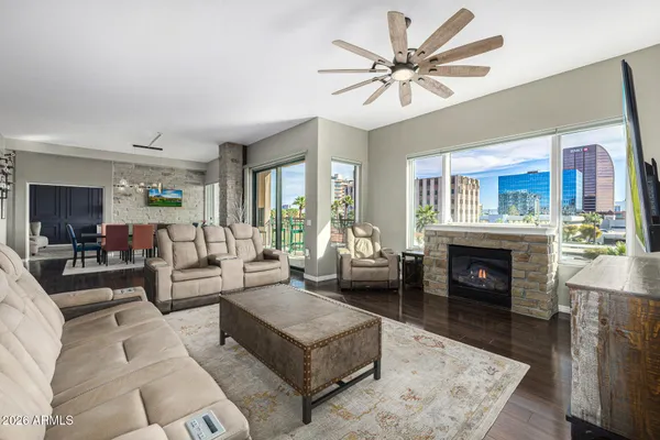 a living room with furniture a fireplace and kitchen view