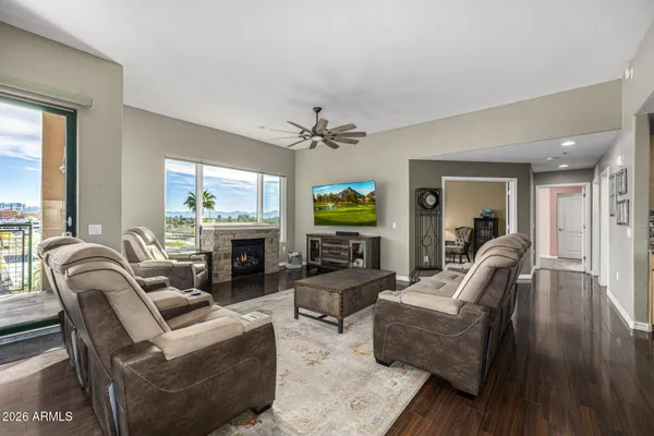 a living room with fireplace furniture and a wooden floor