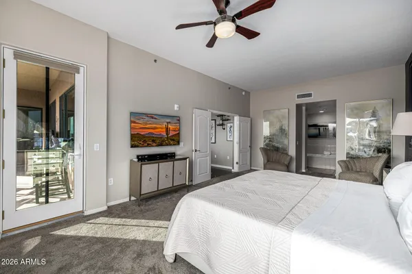 a view of walk in closet with clothes