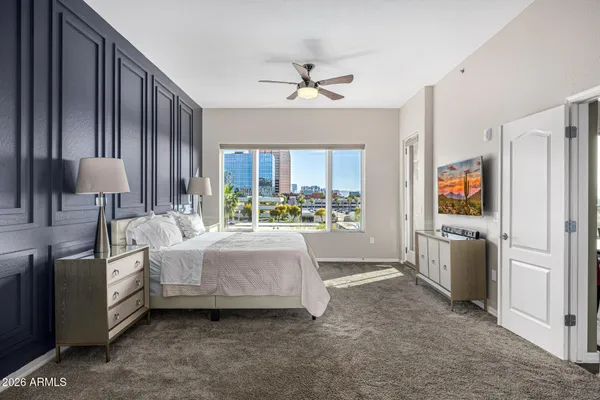 a living room with a bed furniture and a large window