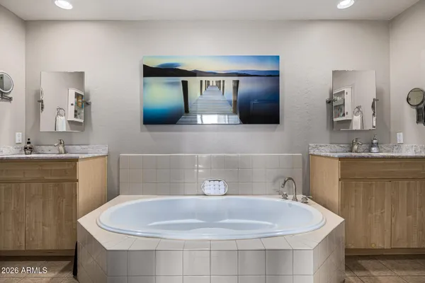 a spacious bedroom with a bed and a flat screen tv