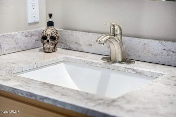 a bedroom with a bed a lamp and a chandelier