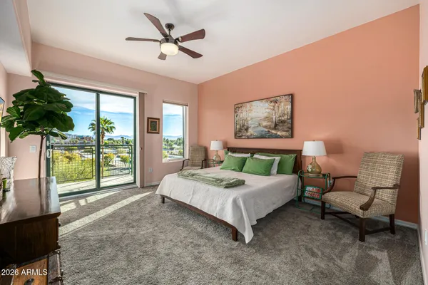a view of a hallway with wooden floor and a living room